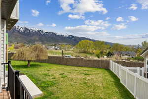 View of yard with a fenced backyard and a mountain view