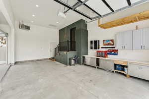 Garage with a garage door opener and recessed lighting
