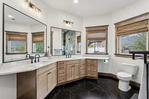 Full bathroom featuring recessed lighting, a shower stall, toilet, vanity, and baseboards