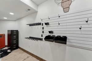 Interior space with baseboards, light wood-style floors, visible vents, and recessed lighting
