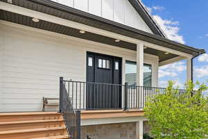 View of exterior entry with covered porch