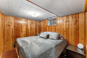 Bedroom with wood walls