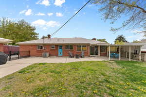 Back of house with brick siding, central AC, a chimney, and a patio