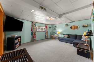 Living room featuring carpet and visible vents