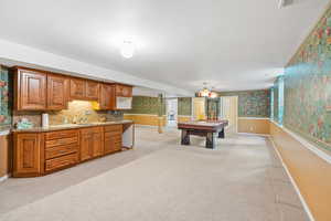 Playroom featuring wallpapered walls, light carpet, pool table, and a sink