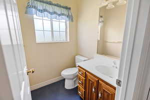 Half bath featuring toilet and vanity