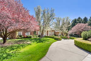 View of front of home featuring a front lawn and brick siding