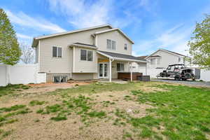 Back of house with a yard, french doors, a hot tub, and fence