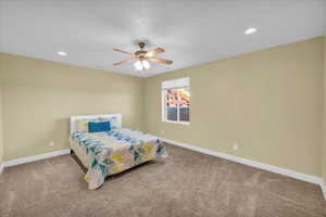 Bedroom featuring recessed lighting, ceiling fan, baseboards, and carpet