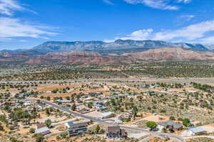 Drone / aerial view featuring view of desert and a mountain view