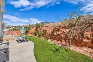 View of yard with fence and a patio