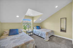 Bedroom featuring recessed lighting, lofted ceiling, baseboards, and carpet