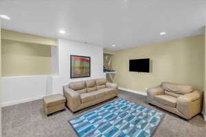 Living area featuring baseboards and recessed lighting
