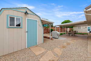 View of shed with a fenced backyard