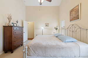 Bedroom with baseboards, high vaulted ceiling, and ceiling fan