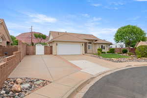 Single story home with a gate, concrete driveway, a tiled roof, fence, and a garage