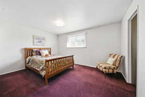 Carpeted bedroom with baseboards
