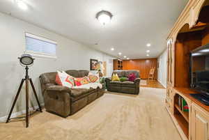 Living room featuring recessed lighting, baseboards, and light colored carpet