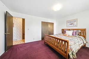 Bedroom featuring a closet, carpet floors, visible vents, and baseboards