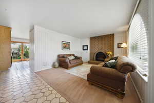 Living area with tile patterned floors and a fireplace
