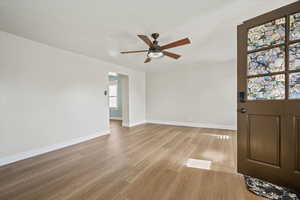 Interior space with light wood-style flooring, baseboards, and ceiling fan