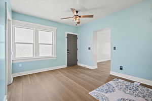 Bedroom featuring ceiling fan, baseboards, and wood finished floors