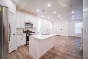 Kitchen with white cabinets, a sink, visible vents, recessed lighting, and appliances with stainless steel finishes