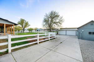 View of home's exterior with fence and a garage