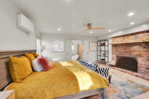 Bedroom with recessed lighting and a brick fireplace