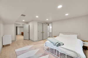 Bedroom featuring visible vents, baseboards, recessed lighting, and light wood-style floors