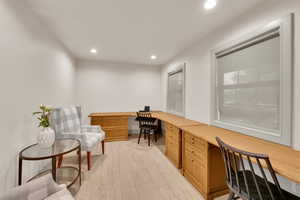 Home office featuring recessed lighting, built in study area, and light wood-style flooring