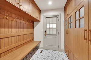 Mudroom featuring tile patterned floors and baseboards