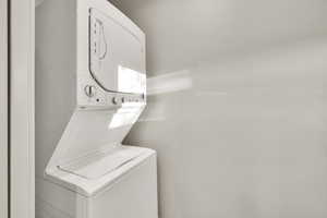 Laundry room with stacked washer / drying machine and laundry area