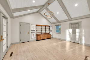 Interior space with baseboards, visible vents, and an inviting chandelier
