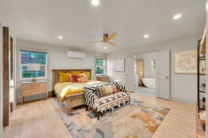 Bedroom with recessed lighting, light wood-style flooring, ceiling fan, and connected bathroom