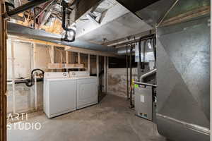 Unfinished below grade area featuring separate washer and dryer