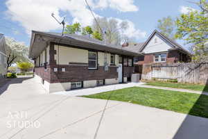 Single story home with fence, a front lawn, cooling unit, a patio, and brick siding