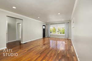 Unfurnished room with hardwood / wood-style flooring, crown molding, and recessed lighting