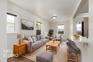 Living room with baseboards and light carpet