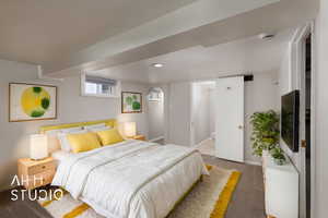 Bedroom with baseboards, carpet floors, and connected bathroom