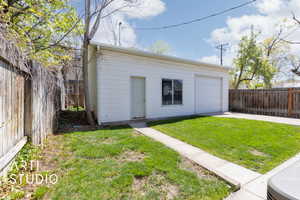 Garage featuring driveway and fence