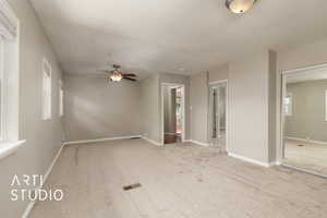 Spare room featuring baseboards, a ceiling fan, visible vents, and carpet