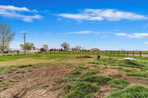 View of yard featuring fence and a rural view