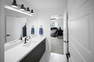 Ensuite bathroom featuring ensuite bathroom, vanity, and marble finish floor