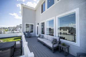 Wooden terrace with outdoor lounge area, a residential view, and fence