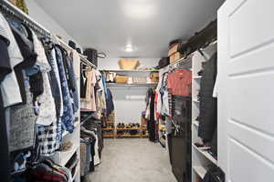 Spacious closet with carpet flooring
