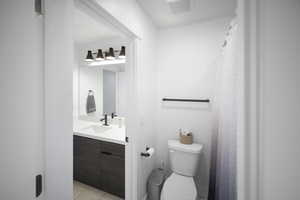 Bathroom featuring toilet, vanity, tile patterned floors, and visible vents
