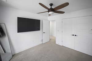 Unfurnished bedroom featuring a ceiling fan, a closet, baseboards, carpet flooring, and visible vents