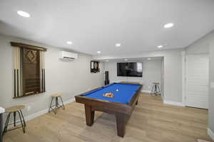 Game room with billiards, a wall mounted AC, light wood-style flooring, baseboards, and recessed lighting