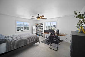 Carpeted bedroom featuring a ceiling fan and visible vents